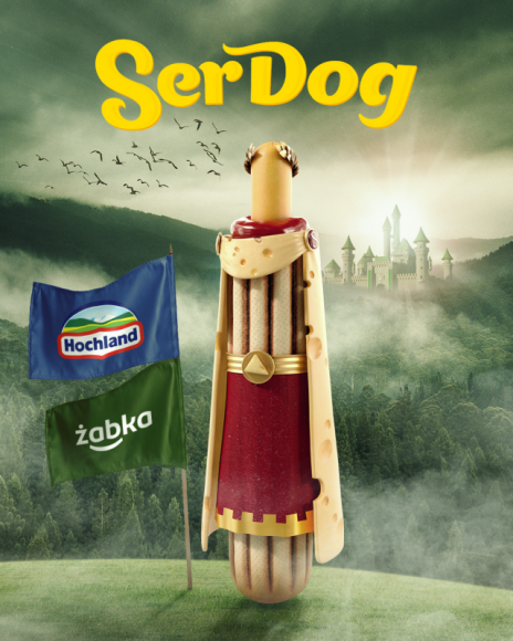 Ser Dog z Hochlandii zagości w Żabce na dłużej Handel, BIZNES - Po udanej ofensywie Imperator Smaku Ser Dog Wspaniały, pogromca mięsożernej rosiczki, na dobre zagości w Żabce. Ser Dog to więcej niż hot dog z parówką. To hot dog z „parówką” serową powstałą m.in. z serów cheddar i maasdamer, przygotowaną przez Hochland.